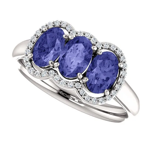 14KT GOLD 1.50 CTW TANZANITE & .10 CTW DIAMOND 3 STONE OVAL HALO RING